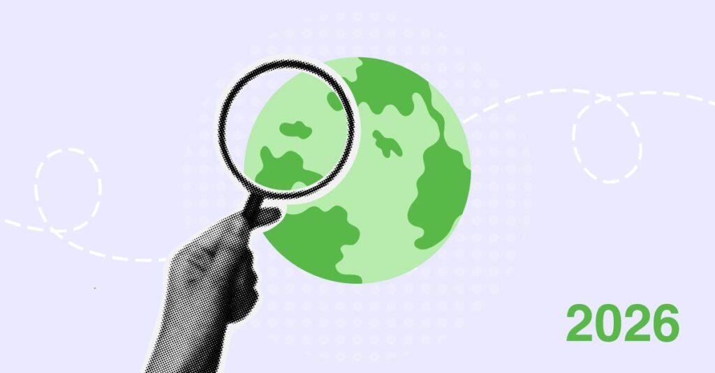 A hand holding a magnifying glass over a world globe, symbolising global search or analysis.